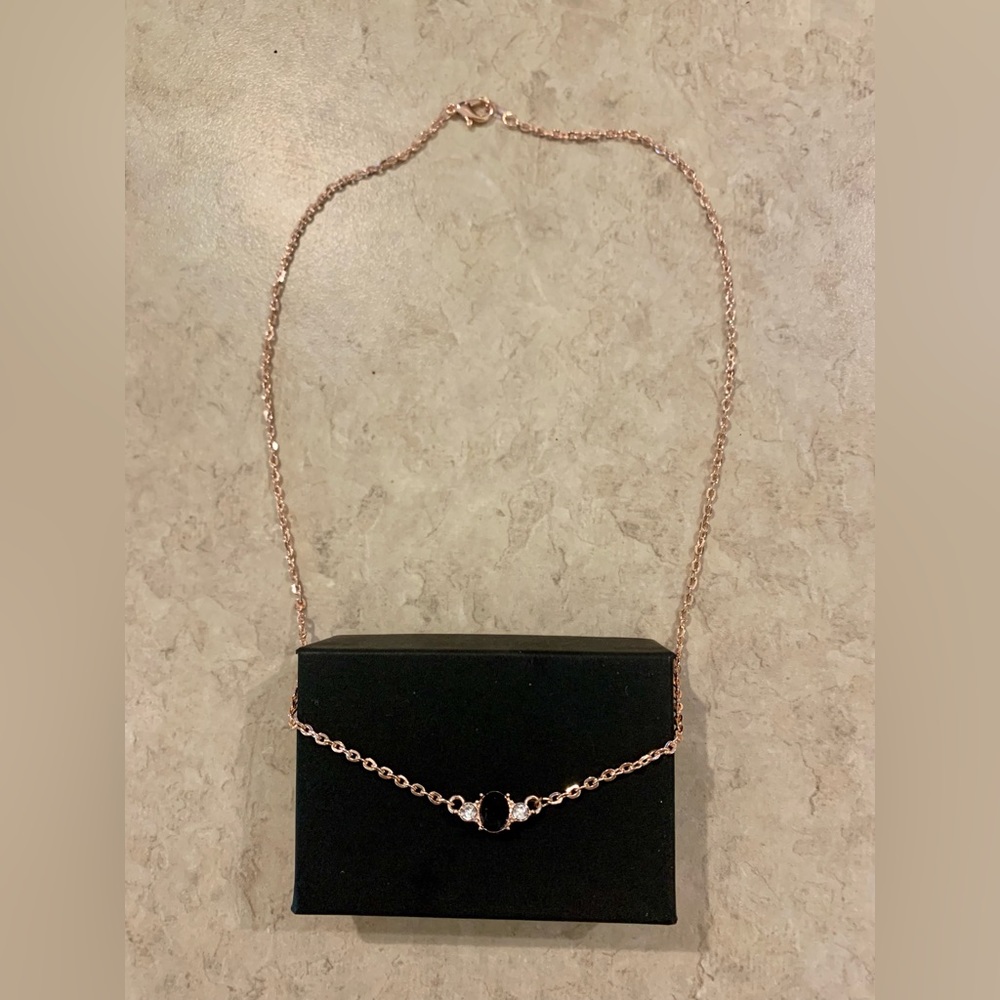 Rose tone natural oval sapphire necklace.